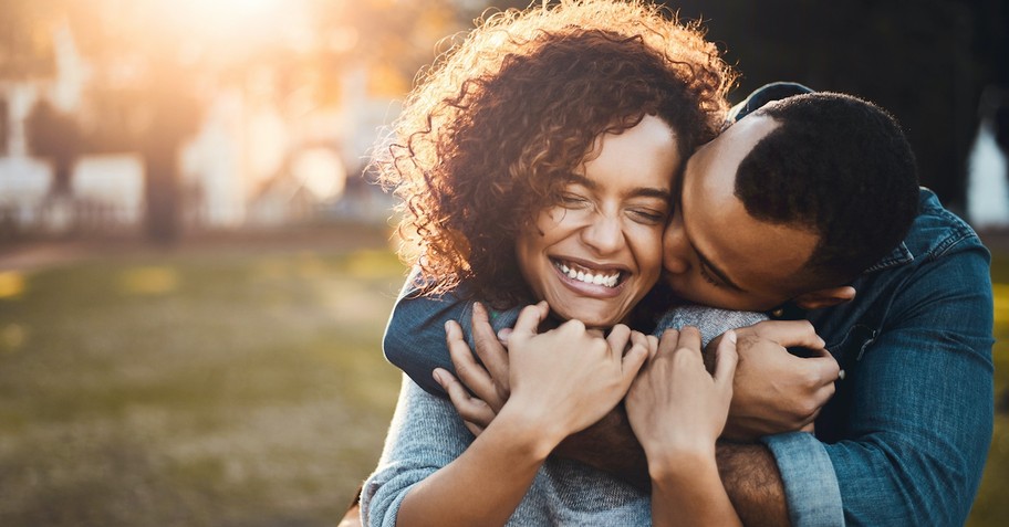 Happy couple hugging and laughing