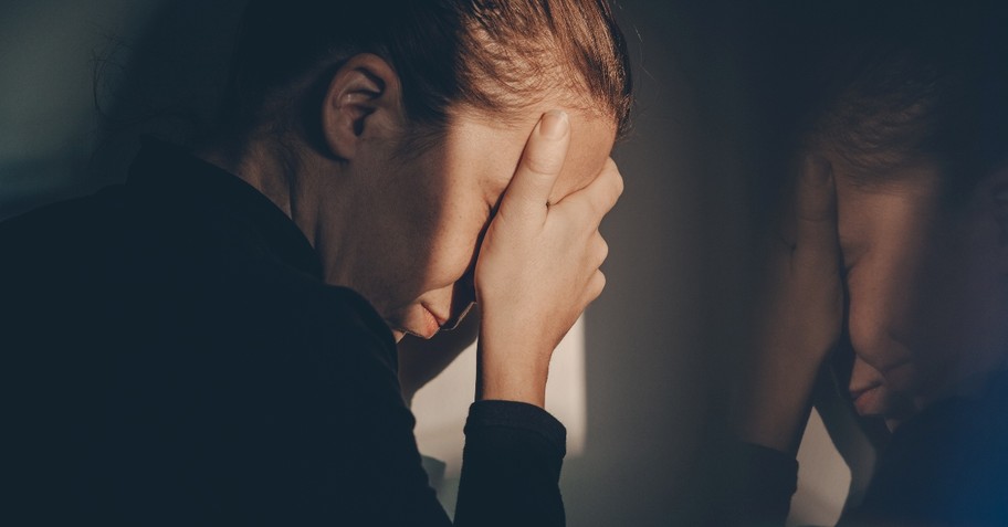 Woman looking sad in the mirror