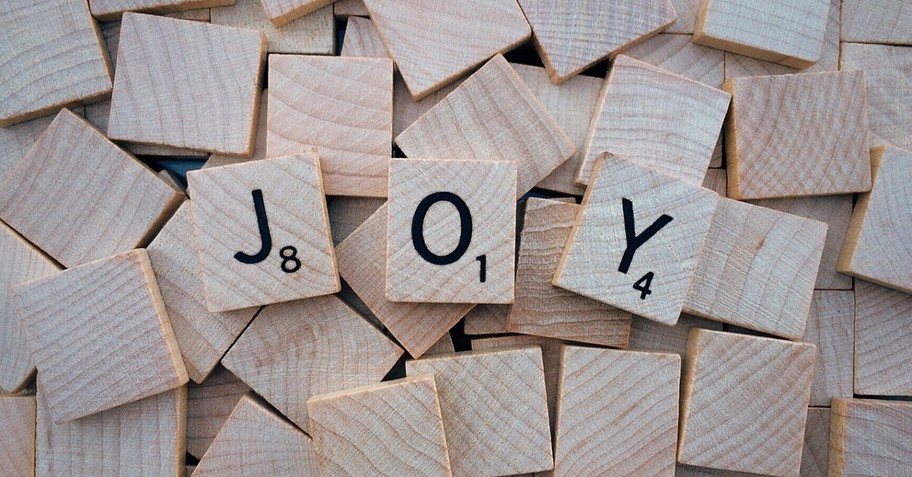 Scrabble tiles spelling joy