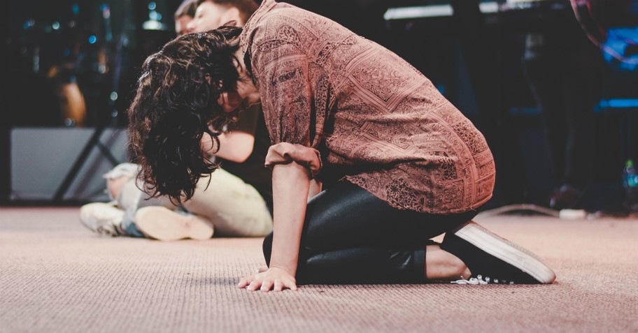 Person kneeling in prayer