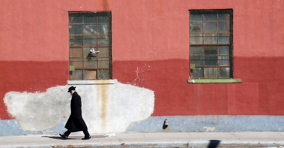 A Jewish man walking down the street