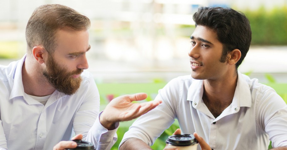 two men of different ethnicities having a conversation