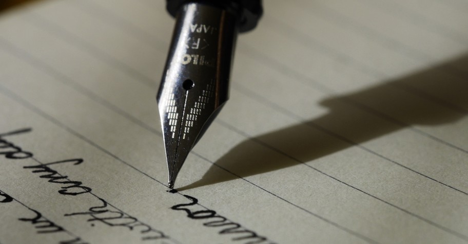 pen writing on paper, names written in lamb's book of life