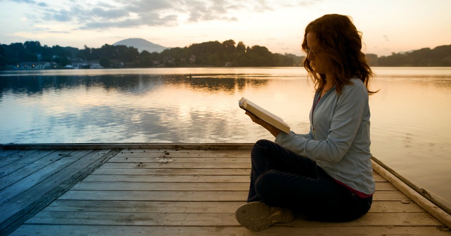 Woman reading the Bible on a dock, living water