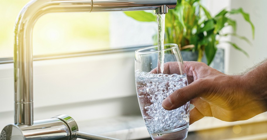 Man filling a glass of water, living water