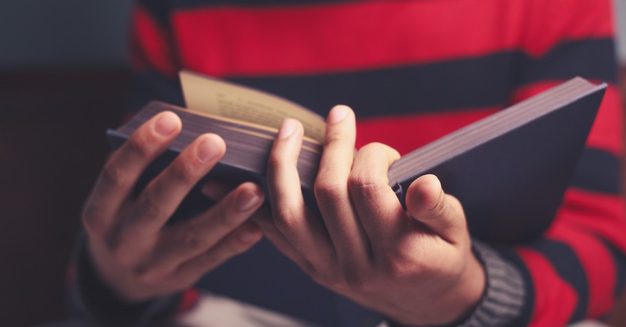 Boy holding an open Bible