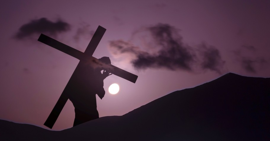 Christ carrying cross up hill at dusk Day of Atonement