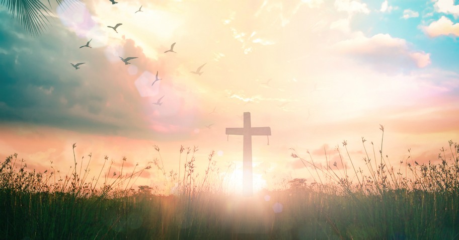 cross in a field with a sunset background, fruit of the spirit