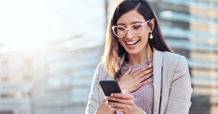 Woman looking surprised at her phone