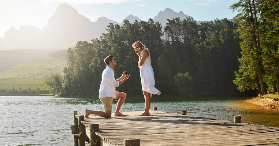 Man proposing to a woman on a dock