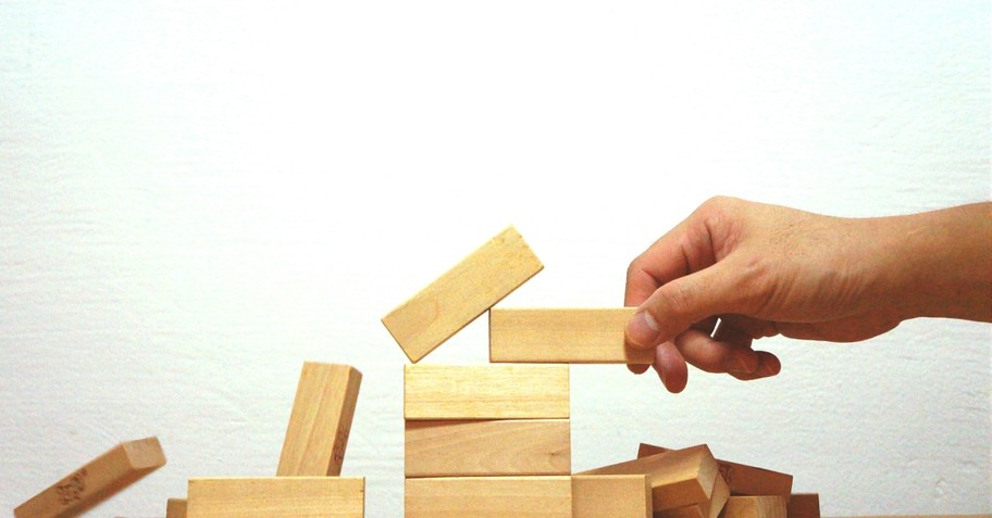 Hand stacking an unsteady stack of blocks