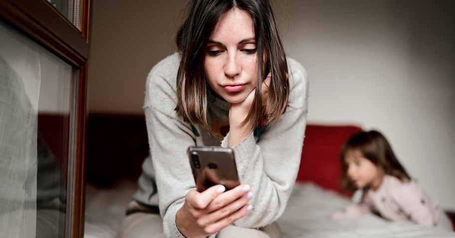 mom on cell phone ignoring child distracted parent