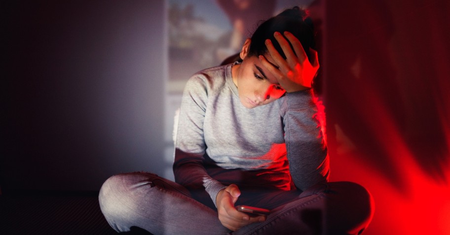 Woman looking at her phone anxiously