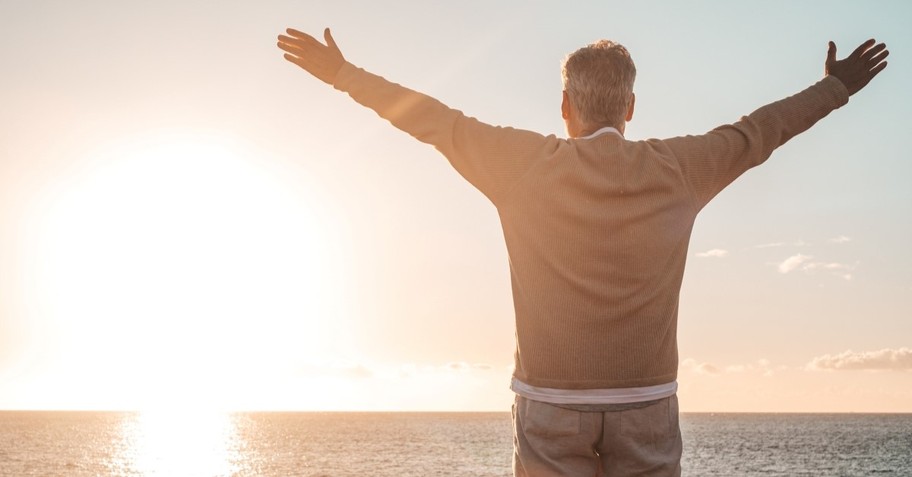 older man looking at sunset on beach, do great things for god in old age