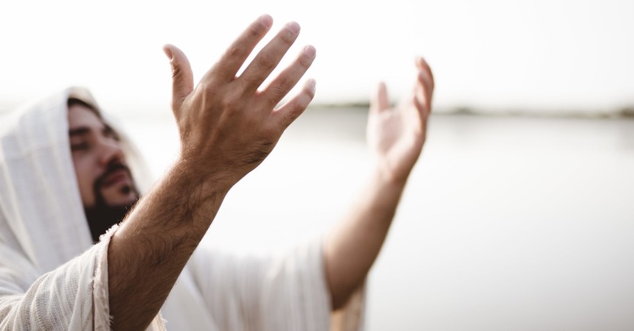 robed man praising god in desert