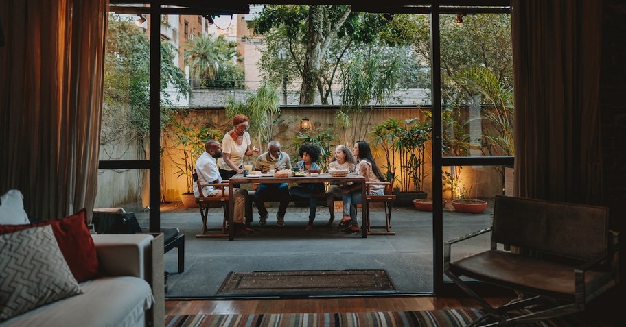 family at home in backyard dinner table eating