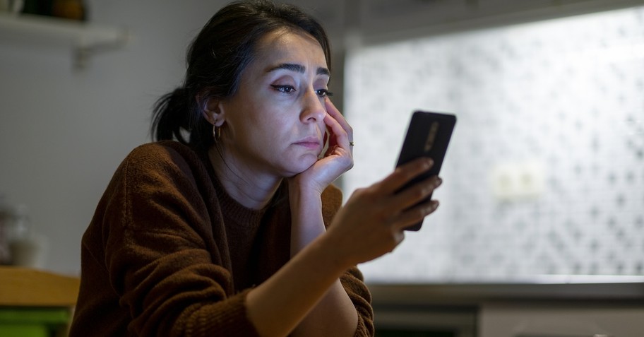 Woman on phone social media posting cellphone stressed overwhelmed