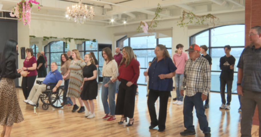 a woman dancing with a group of people