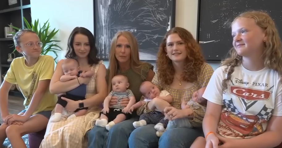 sisters holding 2 sets of newborn twins