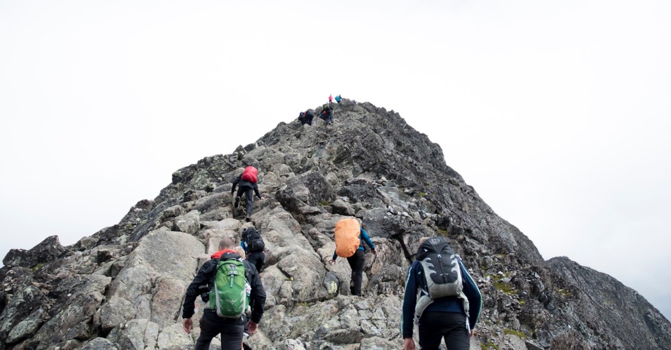 hikers hiking up rock hill leadership