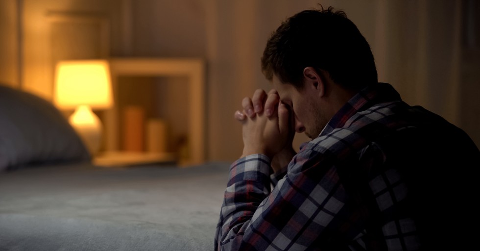 man praying at end of bed before sleep, resist the devil