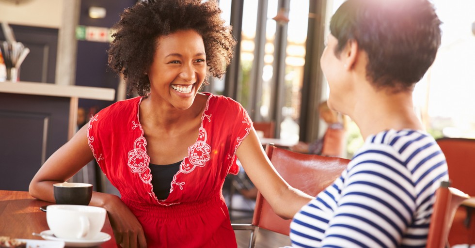 two women friends having a conversation over coffee