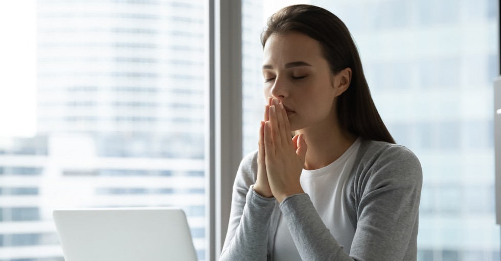 business woman praying for better days ahead