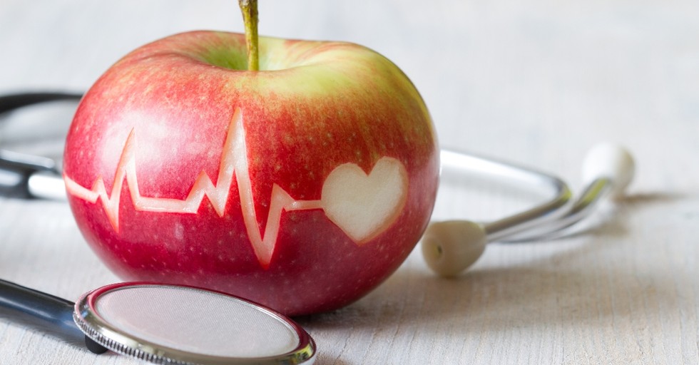 Apple with heart monitor and stethescope