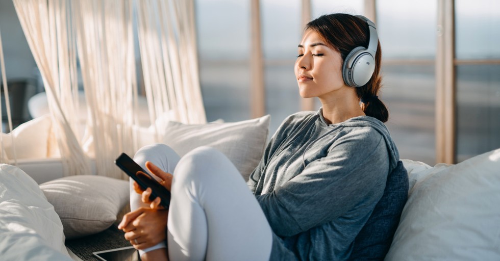 A woman resting and listening to music
